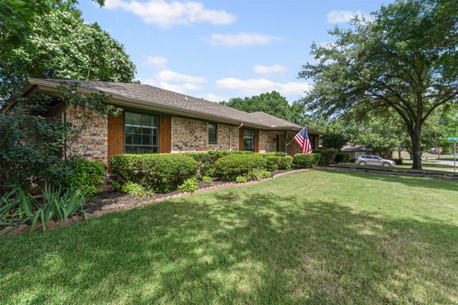 View of front facade featuring a front yard, roof with shingles, and brick siding | Image 32