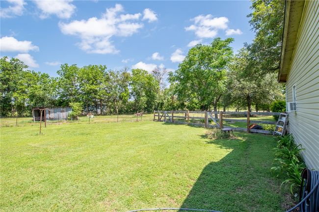 View of yard featuring view of scattered trees and cooling unit | Image 31