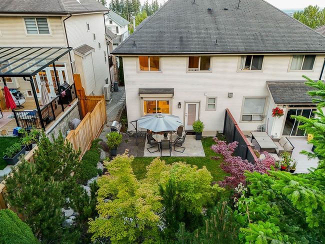 Back of house featuring a patio, a fenced backyard, a shingled roof, and outdoor dining area | Image 37