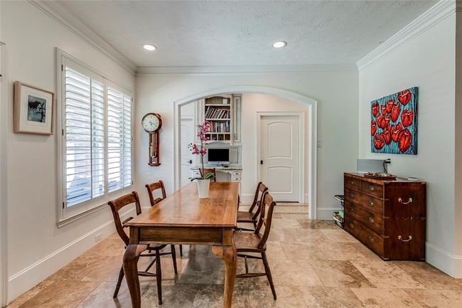 Large breakfast room with tie floor & recessed lighting, window out to the back yard with plantation shutters. Door through to large utility room with lots of hanging space & cupboards. | Image 18
