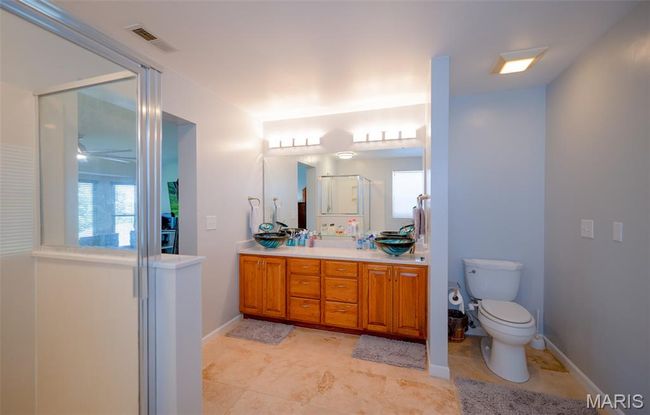 Full bath with vanity, a ceiling fan, an enclosed shower, and plenty of natural light | Image 31