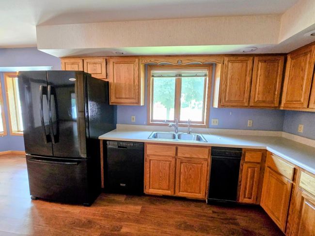 Kitchen has plentiful cabinets-black appliances | Image 13