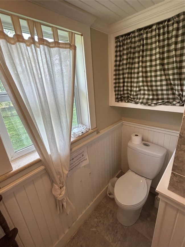 Bathroom with a wainscoted wall and toilet | Image 18