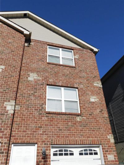 View of home's exterior with a garage | Image 1