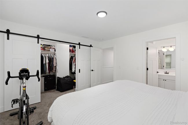 Primary bedroom showing closet doors open | Image 21