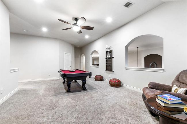As you ascend the stairs, you'll be greeted by the oversized game room, featuring abundant windows that allow natural light to flow in and offer beautiful backyard views. The high ceilings add to the spacious, open feel of the room—truly making this space versatile for endless possibilities. Enjoy the game room, media room, two additional office spaces, and three large guest bedrooms, each with their own attached bathrooms. This floor provides a perfect blend of entertainment, work, and comfort. | Image 24