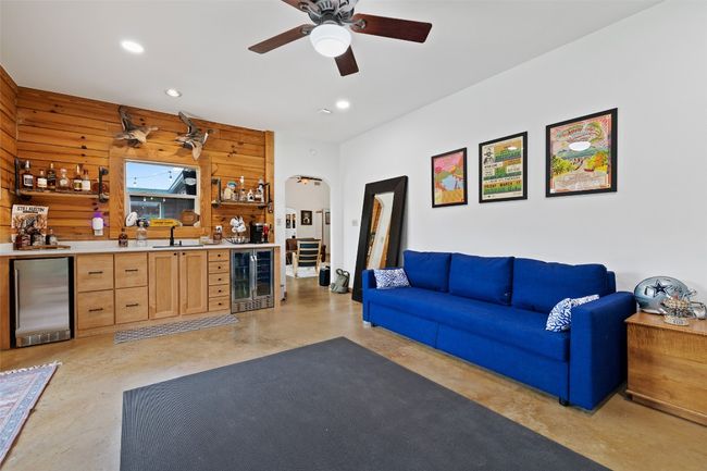 Family room featuring indoor wet bar, frig and wine cooler. Currently being used as the family room, but can be used as the third bedroom. | Image 29