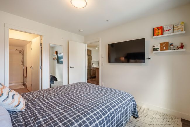Bedroom featuring freestanding refrigerator and baseboards | Image 17