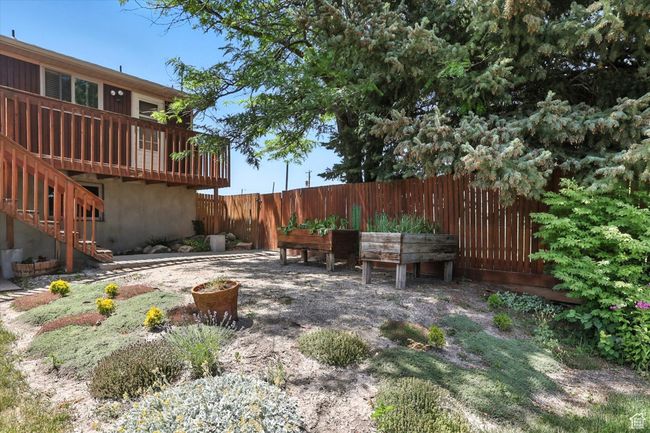 View of yard with a wooden deck and stairs | Image 33