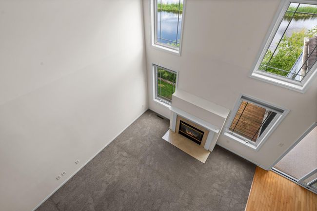 View of the two story living room with lots of light and private view | Image 34