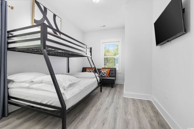 Bedroom with baseboards and wood finished floors | Image 18