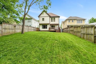 Pet-friendly and entertainer's sanctuary with mature trees in a sidewalk lined neighborhood so close to everywhere you need to be on the west side. Look at all this backyard space and green grass! | Image 2