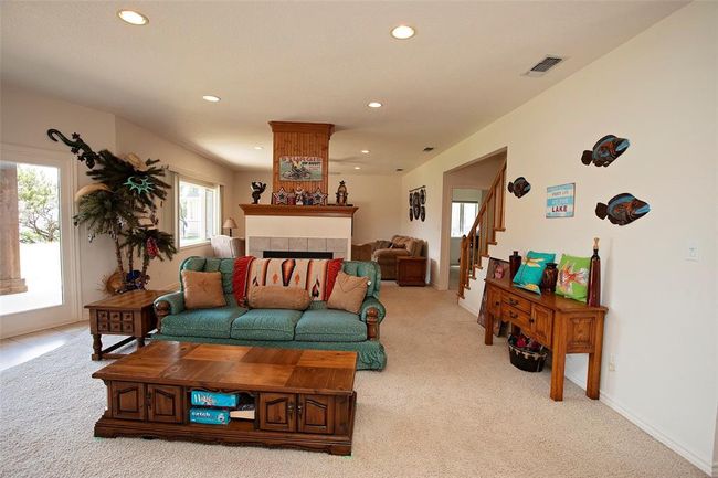 Carpeted living room with ceiling fan | Image 18