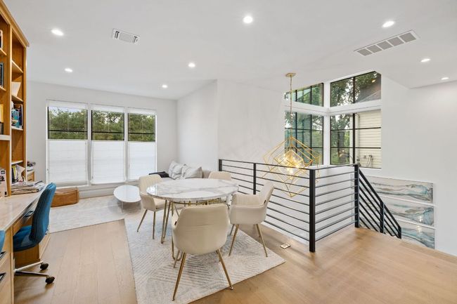 Dining area featuring wood finished floors, recessed lighting, and an office area | Image 21