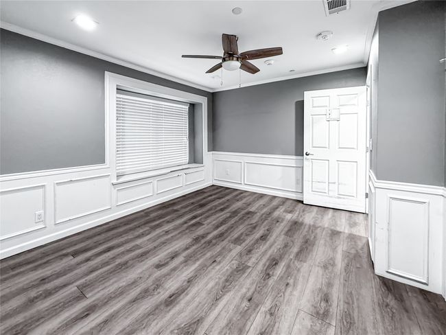 Empty room with ornamental molding, wood finished floors, ceiling fan, recessed lighting, and a decorative wall | Image 17
