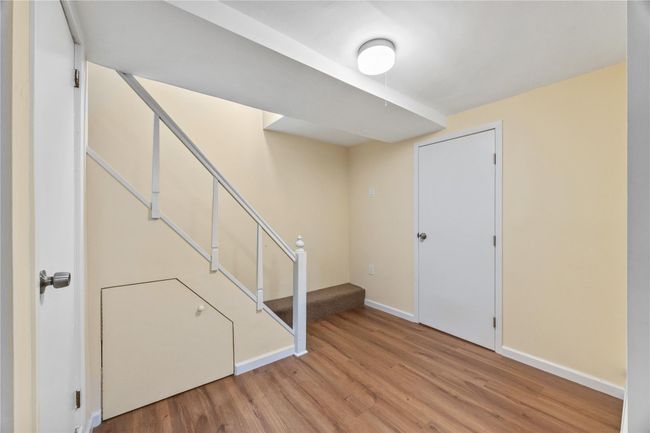 Below grade area featuring wood finished floors and stairway | Image 39