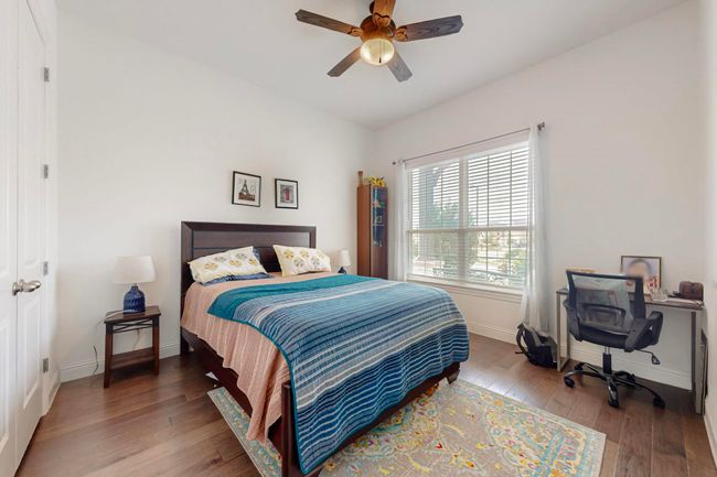 Bedroom featuring hardwood / wood-style floors, ceiling fan, and baseboards | Image 19