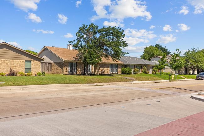 Single story home featuring brick siding, a front lawn, and a chimney | Image 29