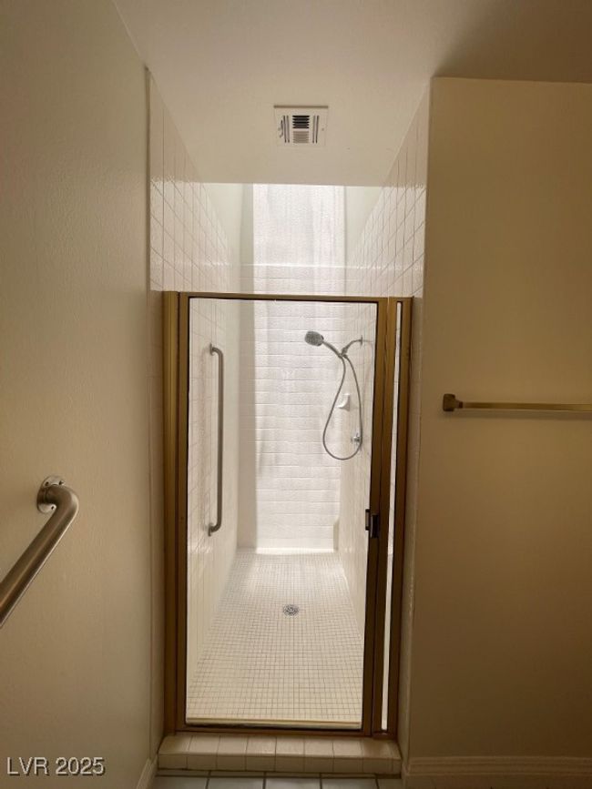 Bathroom with a shower stall and tile patterned flooring | Image 17