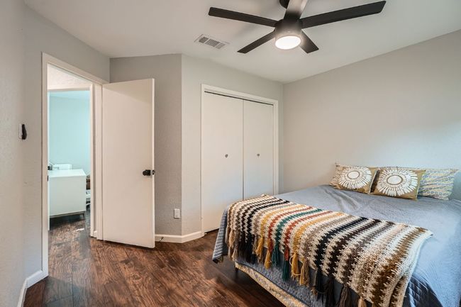 Bedroom featuring wood finished floors, a closet, and a ceiling fan | Image 20