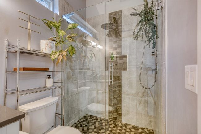 Full bathroom featuring toilet, a stall shower, and vanity | Image 11