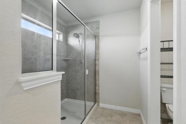 Full bath with a stall shower, toilet, and baseboards | Image 16