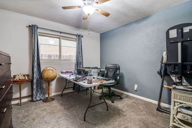 Carpeted office space with a ceiling fan and baseboards | Image 15