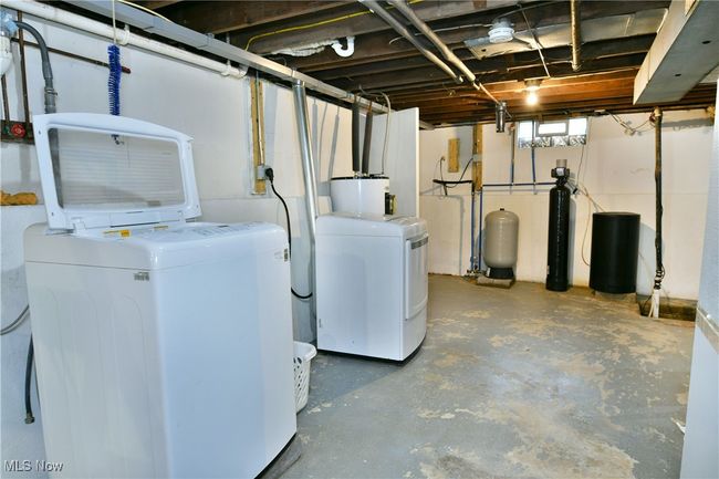 Below grade area with washer and dryer, a water pressure tank, and water heater | Image 37
