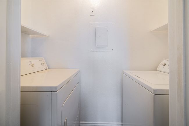 Clothes washing area featuring full size washer and dryer. | Image 20