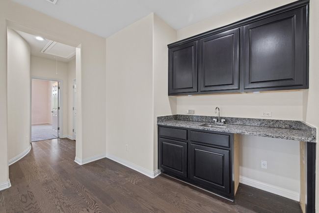 Indoor wet bar featuring dark wood finished floors | Image 27