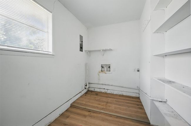 Washroom featuring light wood-type flooring and electric dryer hookup | Image 12