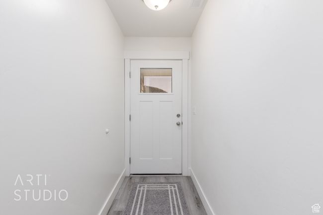 Doorway featuring baseboards and wood finished floors | Image 6