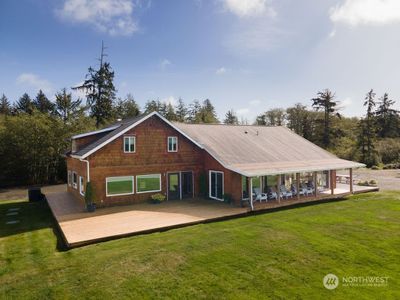 3, 495 sq ft of living space with 1745 of decking, this custom Oly Pen bay side home sits on almost 5 private and secluded acres surrounded by preserved land and yet minutes from the beach and the city of Ocean Shores with backyard boat access to the Bay and Ocean! | Image 1