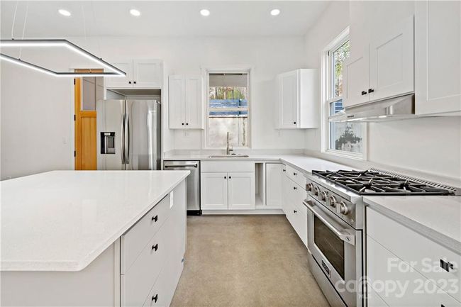 Kitchen area with ample space to cook and entertain. | Image 17