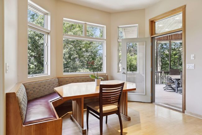What a fabulous nook, banquette located just off kitchen! Great for easy, informal dinner nights!! Perfect for entertaining your crew with easy access to screen porch from breakfast nook. | Image 12