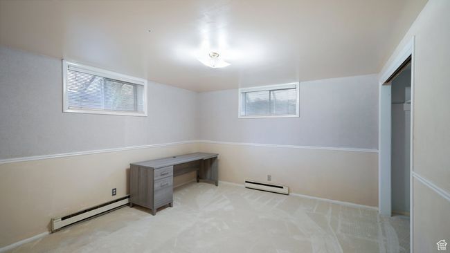 Unfurnished office featuring baseboard heating, carpet flooring, and baseboards | Image 18