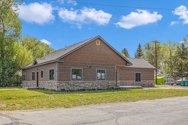 View of side of property featuring stone siding and a lawn | Image 4