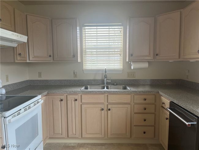 Kitchen featuring a dishwasher, a sink, and electric stove | Image 4