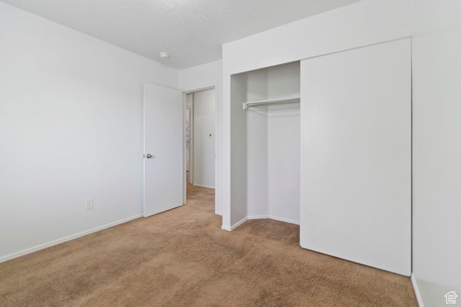 Unfurnished bedroom with carpet floors and a closet | Image 20