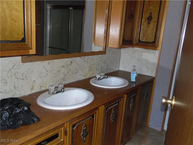Bathroom featuring vanity, tile patterned floors, and backsplash | Image 9