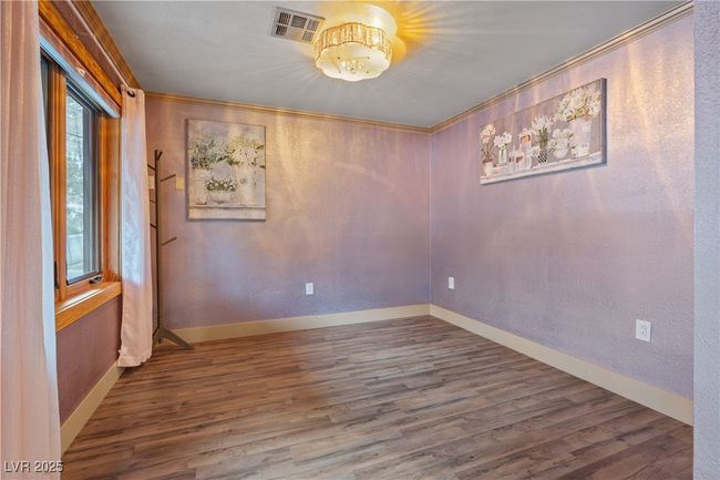 Unfurnished room featuring baseboards, crown molding, visible vents, and wood finished floors | Image 52