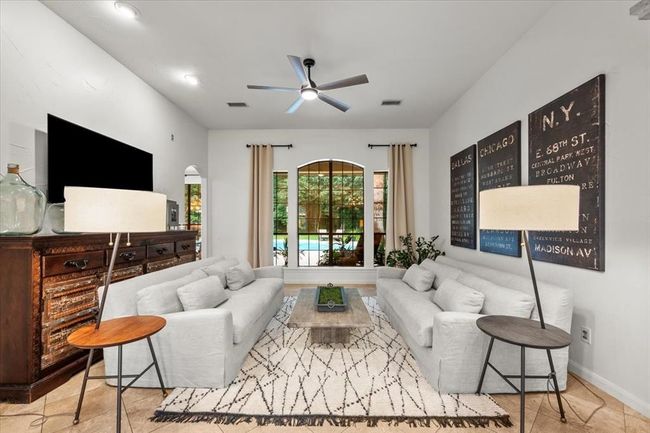 The formal living room draws you in with light-filled windows, graceful architectural lines, and a layout designed for both conversation and comfort. | Image 10