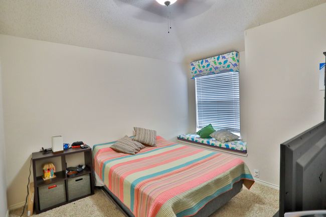 Bedroom featuring carpet, ceiling fan, and a textured ceiling | Image 19