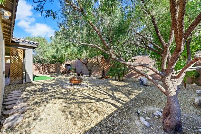 View of yard featuring an outdoor fire pit and a fenced backyard | Image 38