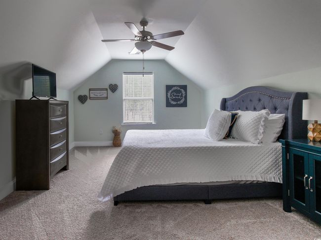 Bedroom featuring ceiling fan, vaulted ceiling, and carpet flooring | Image 22