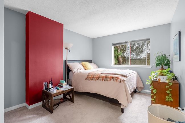 Bedroom featuring baseboards, light colored carpet, and a textured ceiling | Image 13