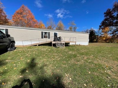 Back of property with a yard and a deck | Image 2