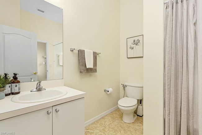 Bathroom featuring tile patterned flooring, vanity, toilet, baseboards, and visible vents | Image 25