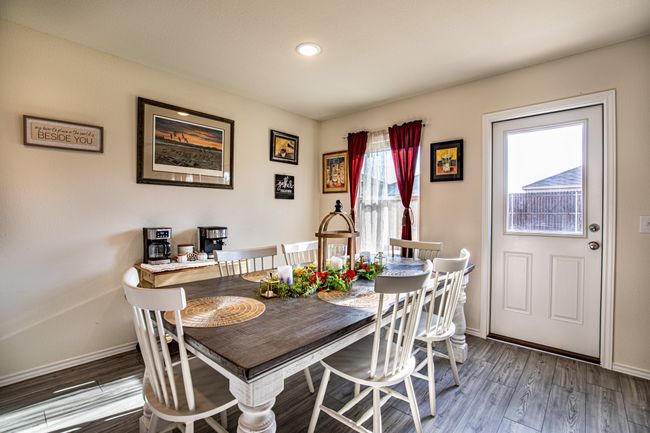 Dining room with wood finished floors and recessed lighting | Image 10
