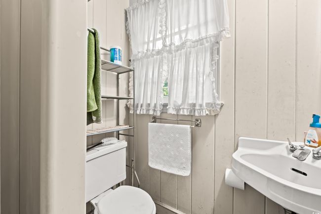 Half bathroom with toilet and a sink | Image 12